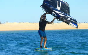 Wing foiler on the mirror-smooth turquoise waters off Somabay beach