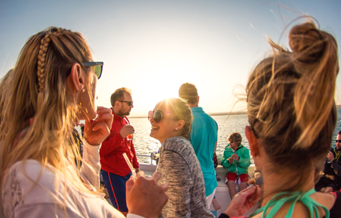 Sunset boat tour in Somabay – guests enjoying the Red Sea views with drinks and music.