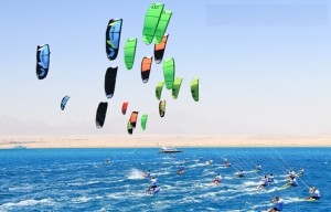Numerous kiters on the mirror-smooth blue sea in front of the KiteHouse in Somabay during the World Cup